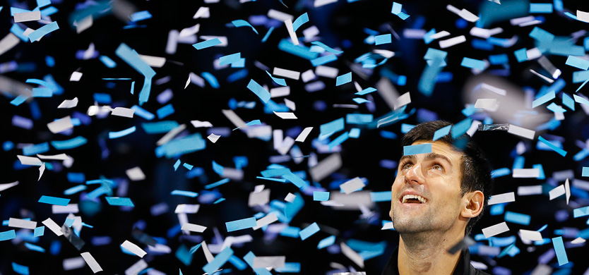 Novak Djokovic of Serbia looks up as confetti falls during the presentation ceremony after he won the ATP World Tour Finals tennis match against Rafael Nadal of Spain at the O2 Arena in London, Monday, Nov. 11, 2013. (AP Photo/Kirsty Wigglesworth)