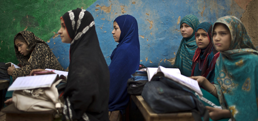 In this Monday, Feb. 23, 2015 photo, Afghan refugee schoolgirls attend a class at a makeshift school on the outskirts of Islamabad, Pakistan. (AP Photo/Muhammed Muheisen)